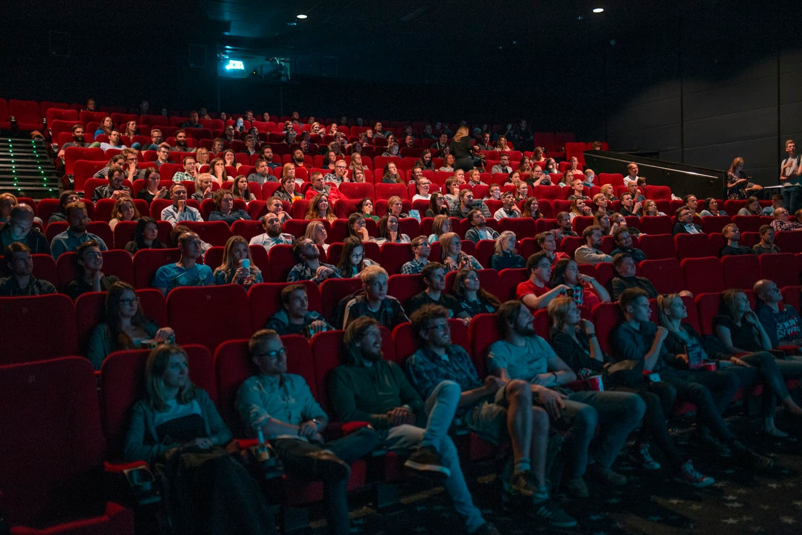 An audience watching a film in a dark cinema